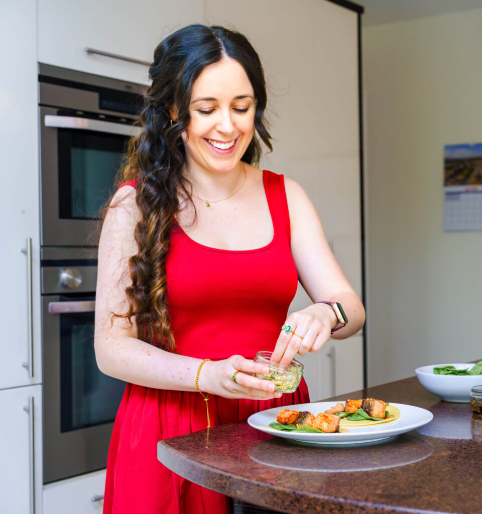 A women feeling happy making a salmon taco.